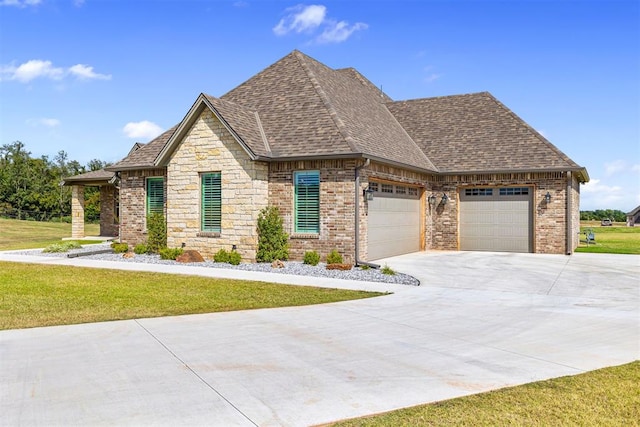 view of front of house with a front yard and a garage