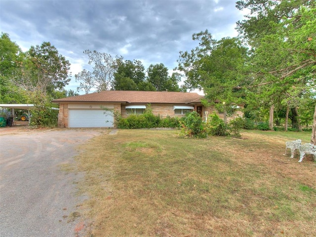 ranch-style home with a garage and a front lawn