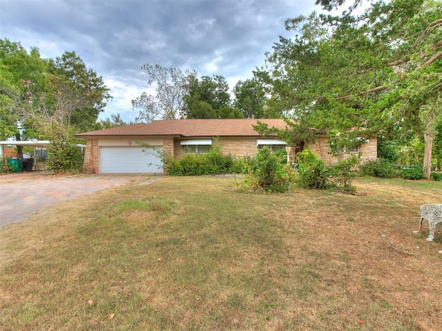 ranch-style home with a garage and a front yard