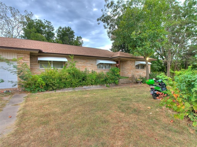 view of front of house with a garage and a front yard