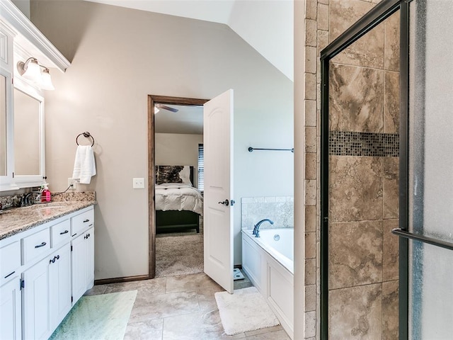 bathroom with vanity, separate shower and tub, and vaulted ceiling