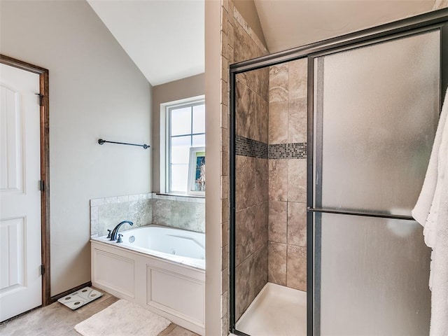 bathroom with tile patterned flooring, independent shower and bath, and vaulted ceiling