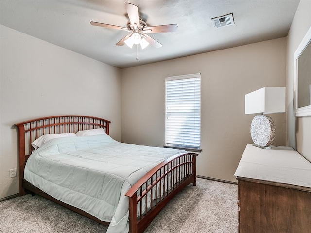 bedroom featuring light carpet and ceiling fan