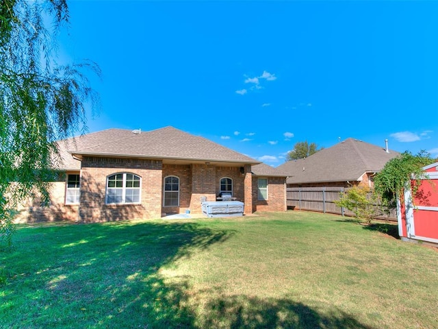 view of front of home with a patio and a front lawn