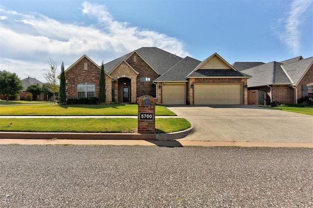 view of front of house with a front lawn and a garage