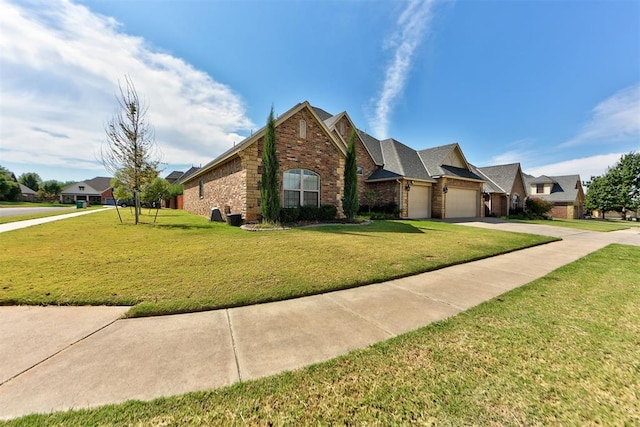 view of front of property featuring a garage and a front lawn