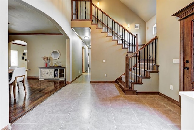 foyer with hardwood / wood-style floors and crown molding