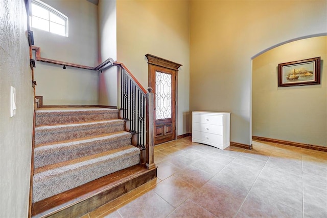 tiled foyer entrance with a high ceiling