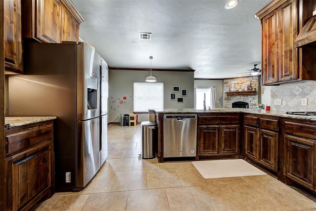 kitchen with ceiling fan, ornamental molding, decorative light fixtures, custom range hood, and stainless steel appliances