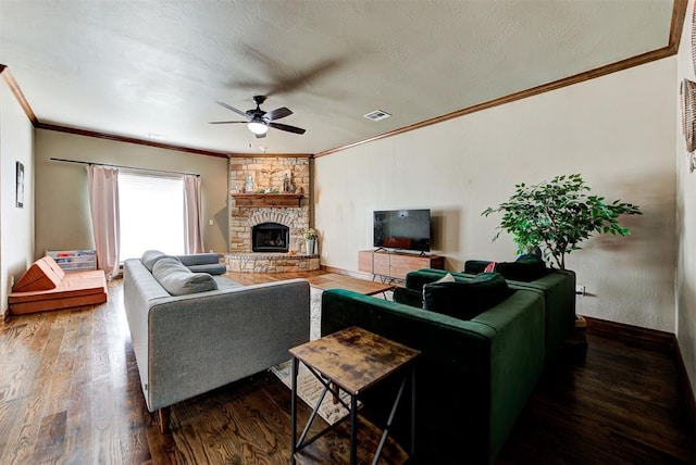 living room with a fireplace, dark hardwood / wood-style floors, ceiling fan, and ornamental molding