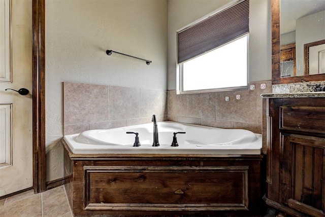 bathroom featuring tile patterned floors, vanity, and a tub