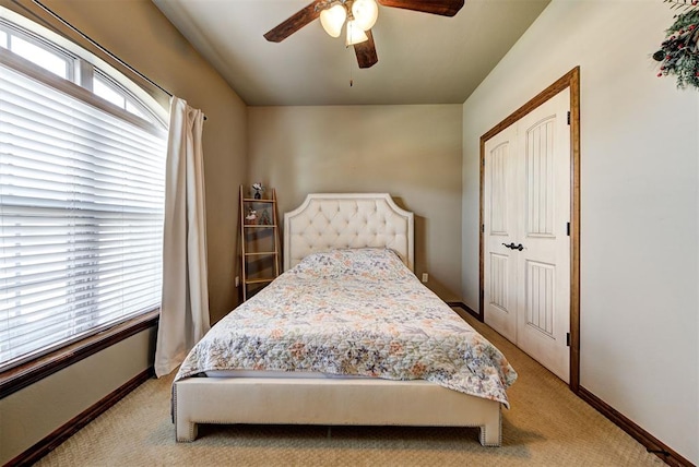 carpeted bedroom with a closet and ceiling fan