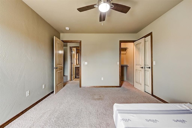 unfurnished bedroom featuring ceiling fan and light colored carpet