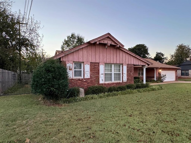 view of front of house featuring a garage and a lawn