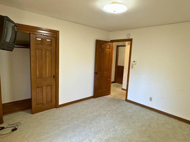 unfurnished bedroom featuring light carpet