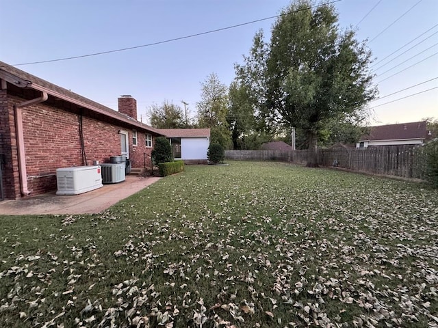 view of yard featuring a patio and central AC unit