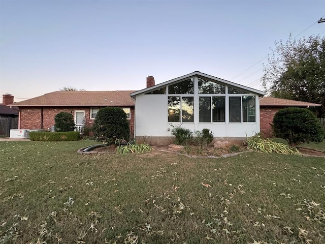 exterior space with a front yard and a sunroom