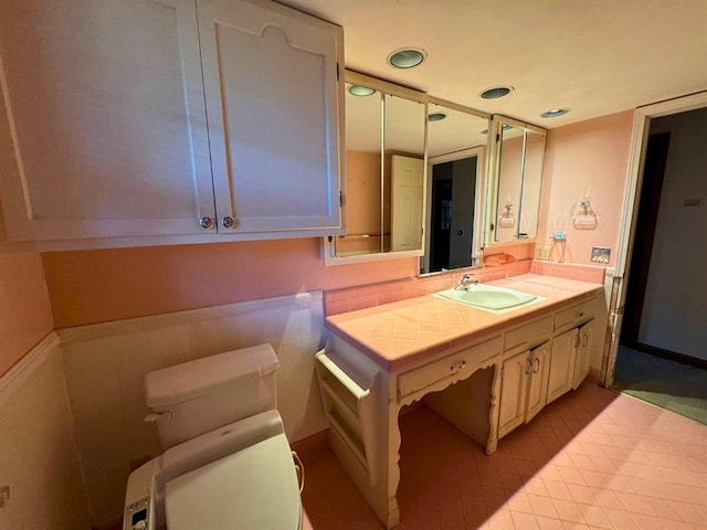 bathroom featuring tile patterned floors, vanity, and toilet