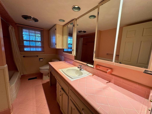 full bathroom with tile patterned floors, vanity, shower / bath combination with curtain, and toilet