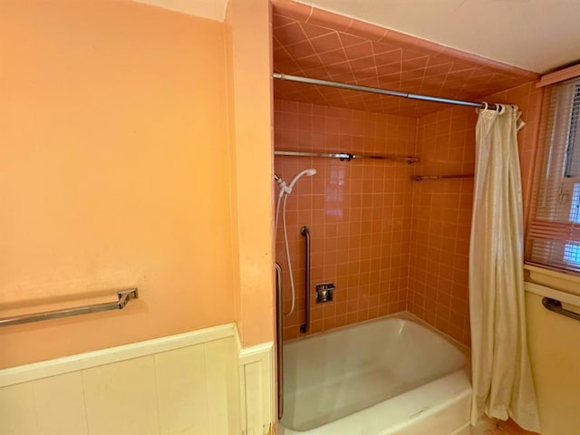 bathroom with shower / bath combo with shower curtain