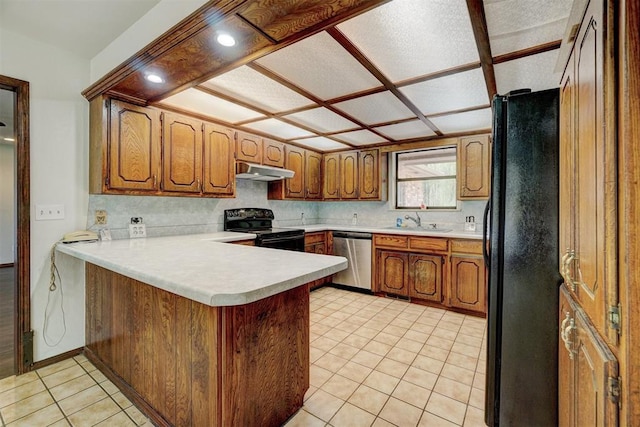 kitchen featuring sink, tasteful backsplash, kitchen peninsula, light tile patterned floors, and black appliances