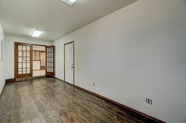 unfurnished room with french doors and dark hardwood / wood-style flooring