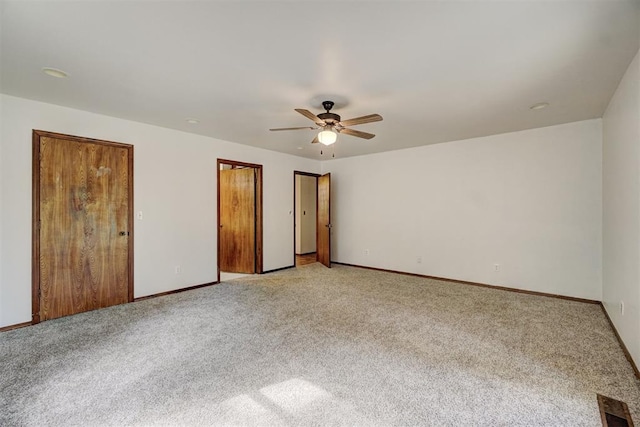 unfurnished bedroom with ceiling fan and light carpet