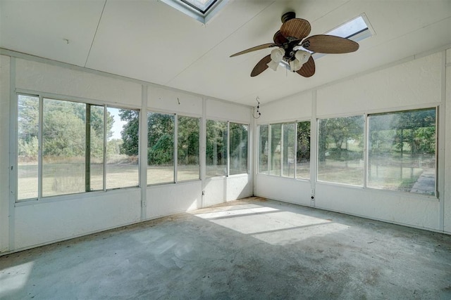 unfurnished sunroom with ceiling fan and vaulted ceiling with skylight