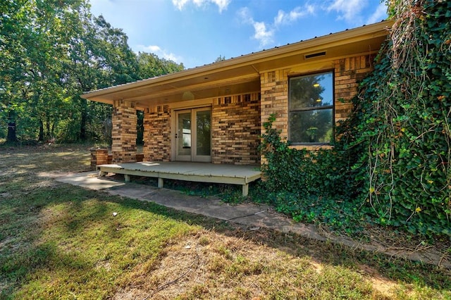 exterior space featuring a deck and a lawn