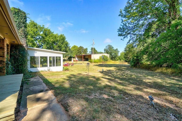 view of yard with a sunroom