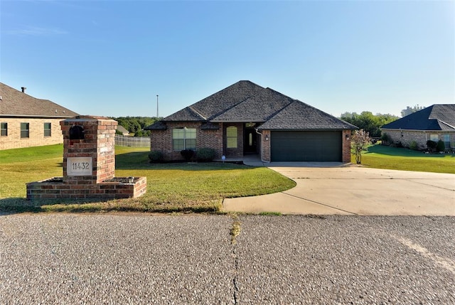 view of front of property with a garage and a front lawn