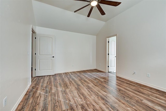 empty room with ceiling fan, wood-type flooring, and vaulted ceiling