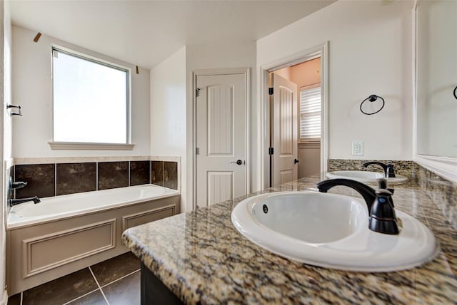 bathroom with tile patterned flooring, vanity, and a bathtub