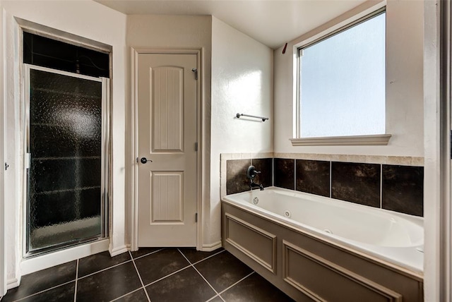 bathroom with tile patterned flooring and shower with separate bathtub