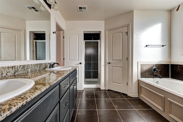 bathroom featuring tile patterned flooring, vanity, and separate shower and tub