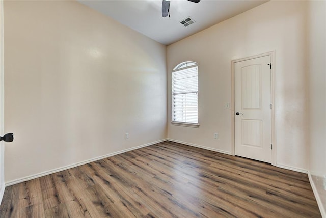 spare room with ceiling fan and dark wood-type flooring