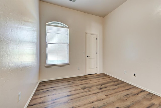 empty room with hardwood / wood-style floors