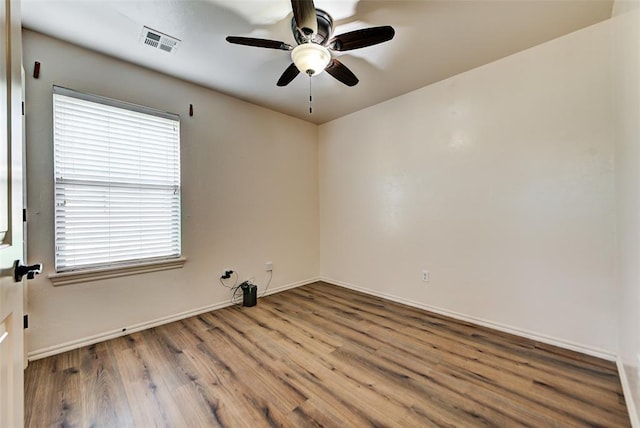 unfurnished room with ceiling fan and hardwood / wood-style floors