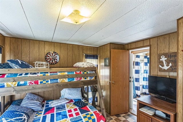 bedroom with wood walls