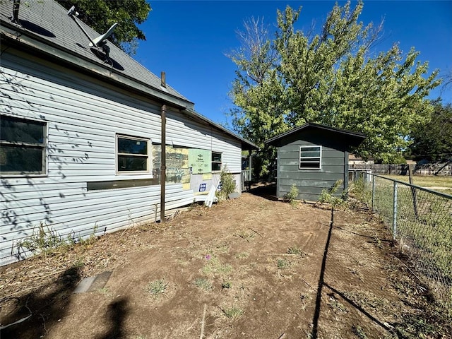 view of side of property featuring a shed