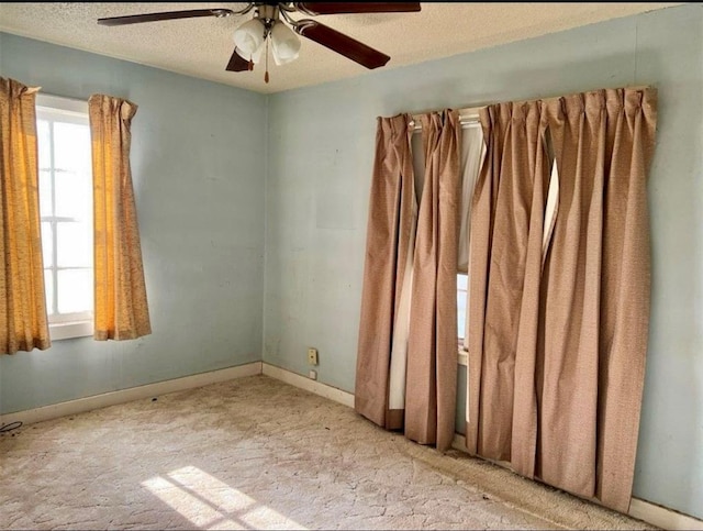 unfurnished room featuring ceiling fan and a textured ceiling