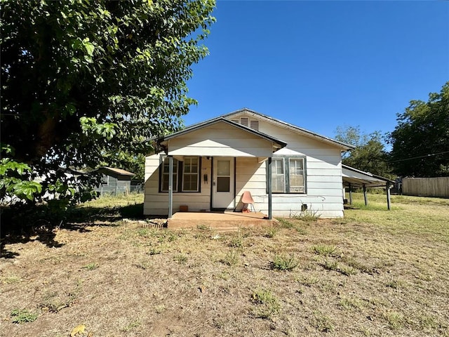 bungalow with covered porch and a carport