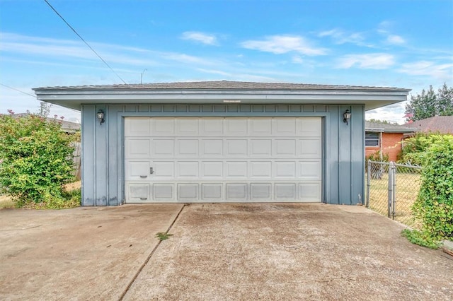 detached garage featuring fence