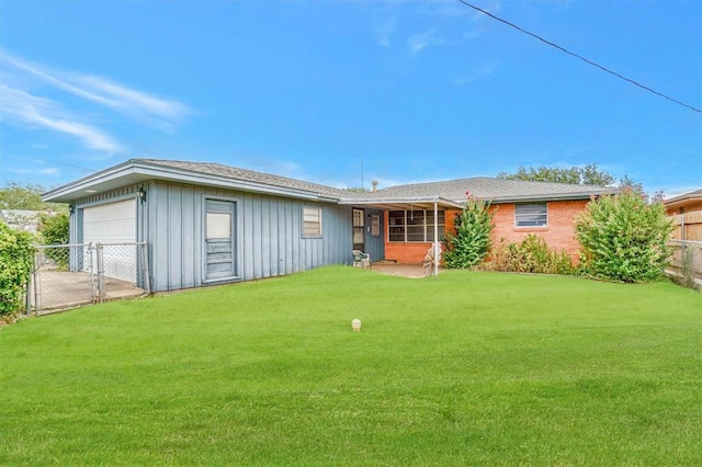 rear view of property with brick siding, fence, board and batten siding, and a yard