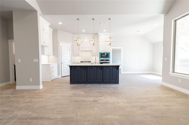 kitchen with light countertops, visible vents, white cabinetry, stainless steel oven, and built in microwave