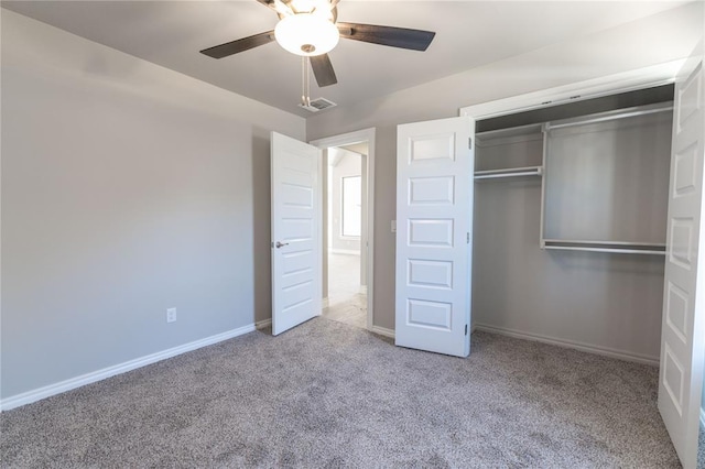 unfurnished bedroom featuring baseboards, visible vents, a ceiling fan, carpet floors, and a closet