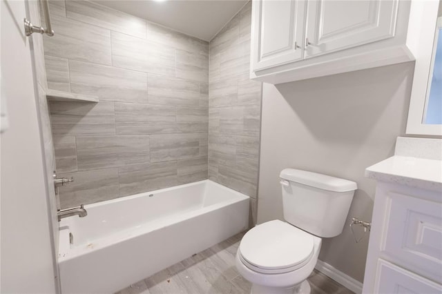 bathroom with baseboards, tub / shower combination, vanity, and toilet