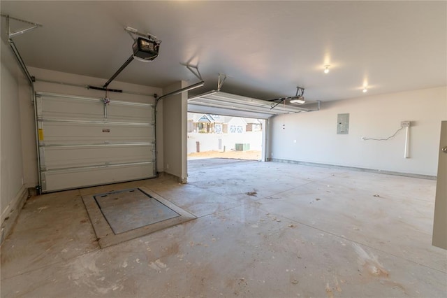 garage featuring electric panel and a garage door opener