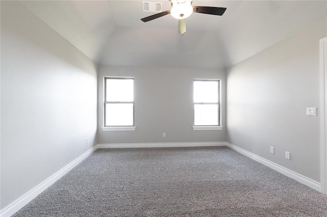 unfurnished room with lofted ceiling, visible vents, carpet flooring, and a healthy amount of sunlight