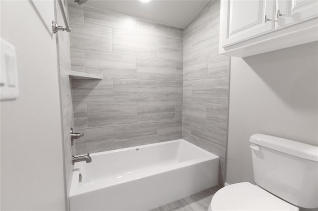bathroom with tub / shower combination and toilet